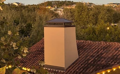 Custom chimney cap installed on a stucco chimney